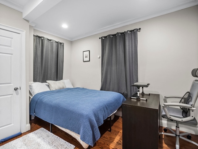 bedroom with dark hardwood / wood-style floors and ornamental molding