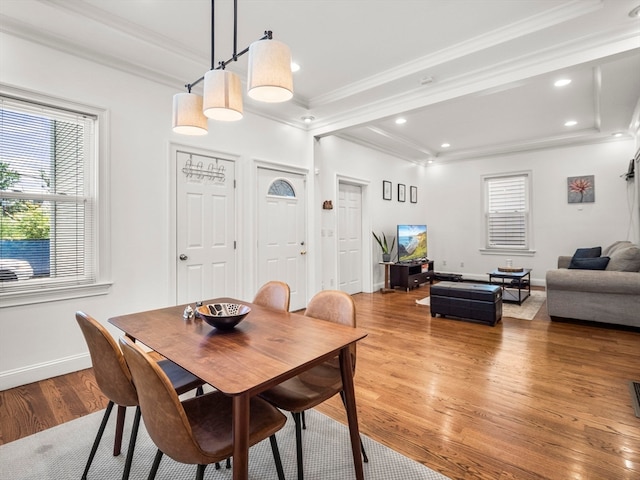 dining area featuring hardwood / wood-style floors and ornamental molding