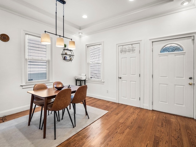 dining room with a raised ceiling and hardwood / wood-style flooring