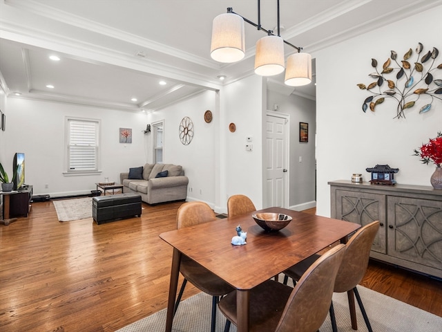 dining space featuring ornamental molding and hardwood / wood-style flooring