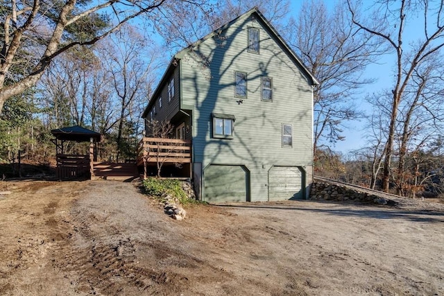 exterior space with a wooden deck and a garage