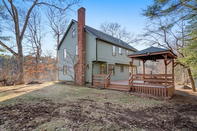 rear view of property featuring a wooden deck