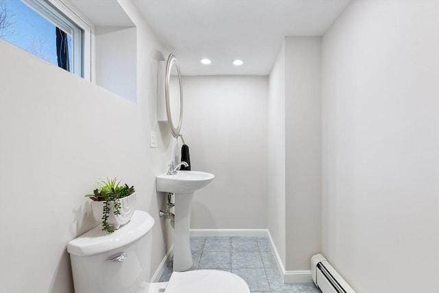 half bath with toilet, tile patterned floors, recessed lighting, baseboards, and a baseboard radiator