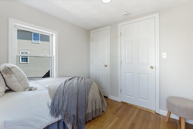 bedroom with baseboards and light wood-type flooring