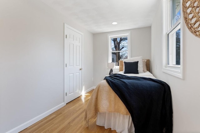 bedroom featuring recessed lighting, baseboards, and light wood-style flooring
