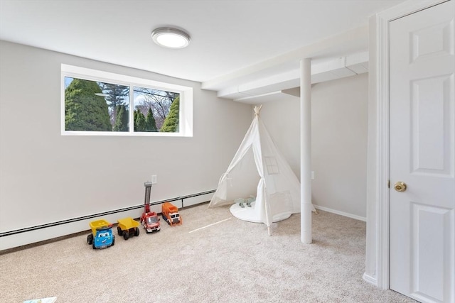 recreation room featuring carpet flooring and a baseboard radiator
