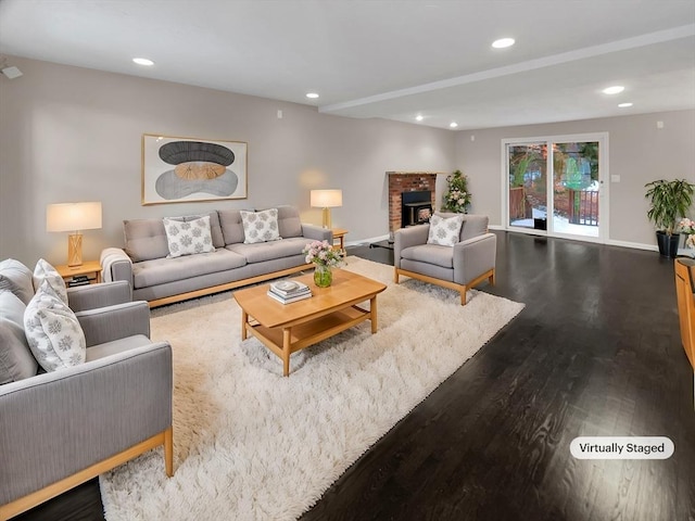 living area with a fireplace, baseboards, wood finished floors, and recessed lighting