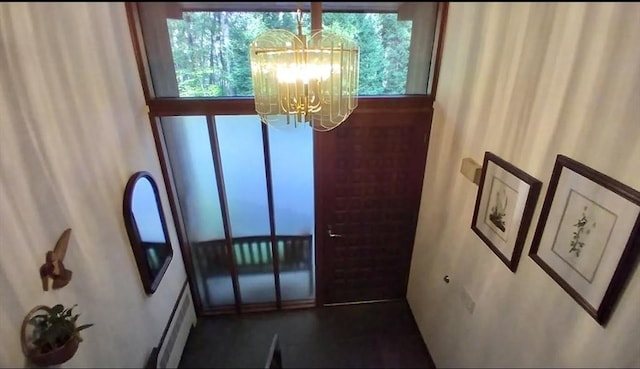 94 Bingham Rd, Carlisle, MA 01741 - entrance foyer featuring a chandelier and a baseboard heating unit