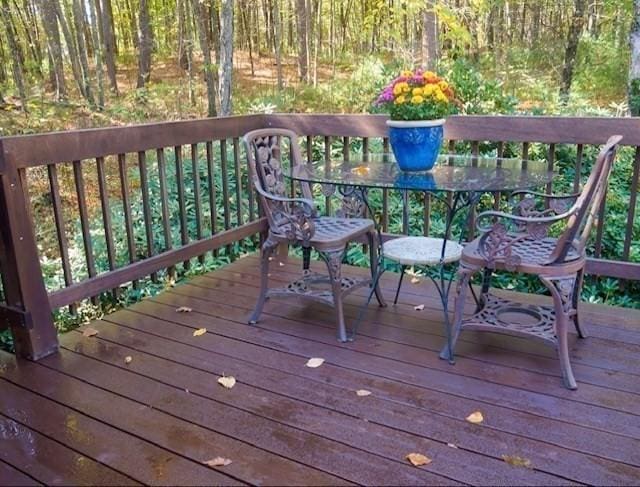 94 Bingham Rd, Carlisle, MA 01741 - deck featuring outdoor dining space and a forest view