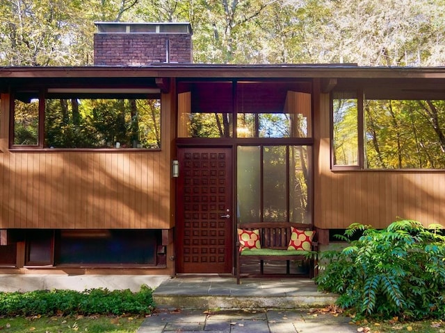 94 Bingham Rd, Carlisle, MA 01741 - view of exterior entry with a chimney