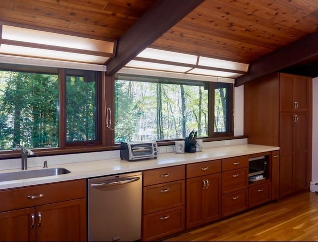 94 Bingham Rd, Carlisle, MA 01741 - kitchen with stainless steel dishwasher, wooden ceiling with exposed beams, a sink, wood finished floors, and brown cabinets