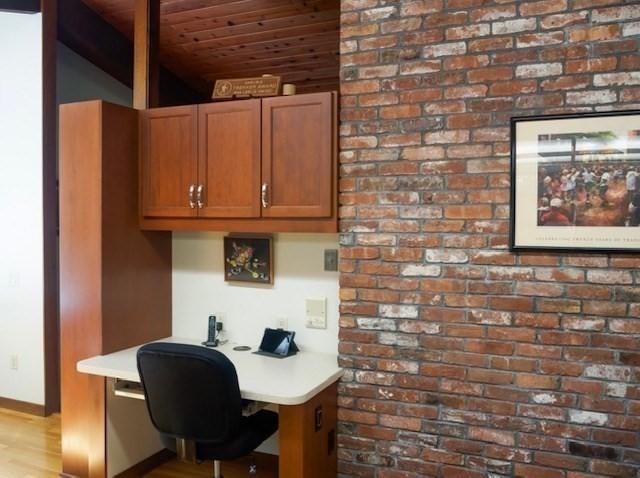 94 Bingham Rd, Carlisle, MA 01741 - office featuring built in study area, wood ceiling, wood finished floors, and brick wall