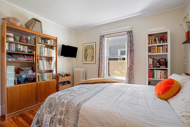 69 Bradfield Ave Unit 1, Boston, MA 02131 - bedroom featuring radiator heating unit, wood finished floors, and crown molding