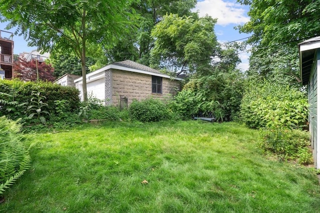 69 Bradfield Ave Unit 1, Boston, MA 02131 - view of grassy yard featuring an outbuilding and a garage