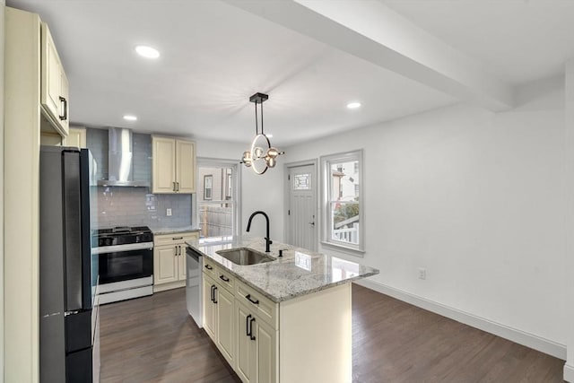 kitchen with sink, stainless steel appliances, light stone countertops, an island with sink, and wall chimney exhaust hood