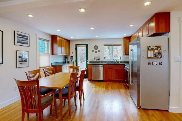 dining room with recessed lighting and light wood-style flooring