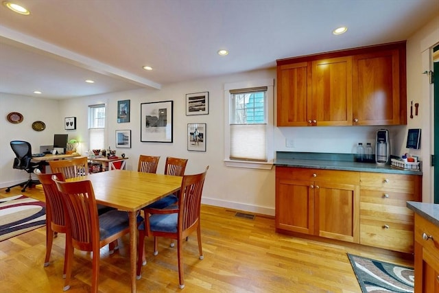 dining room featuring plenty of natural light, recessed lighting, baseboards, and light wood-style floors