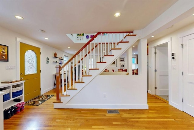 foyer entrance featuring recessed lighting, visible vents, and wood finished floors