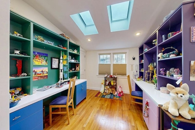 office space featuring built in shelves, light wood-type flooring, and baseboards