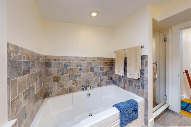 bathroom with a shower stall and a garden tub