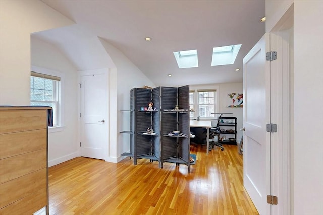 home office with lofted ceiling, recessed lighting, light wood-style floors, and baseboards