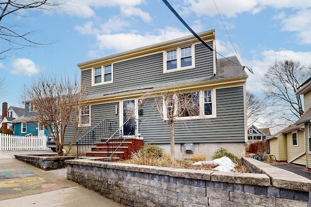 bungalow-style home featuring fence