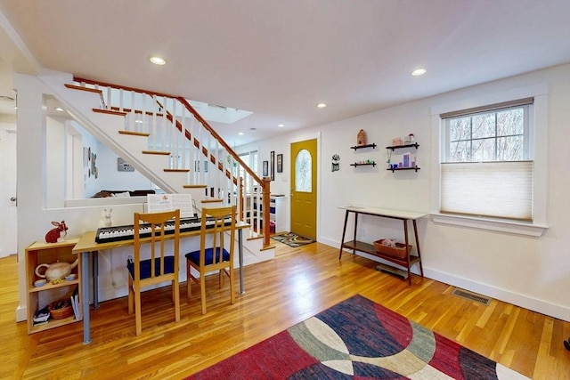 interior space featuring recessed lighting, visible vents, wood finished floors, and stairs