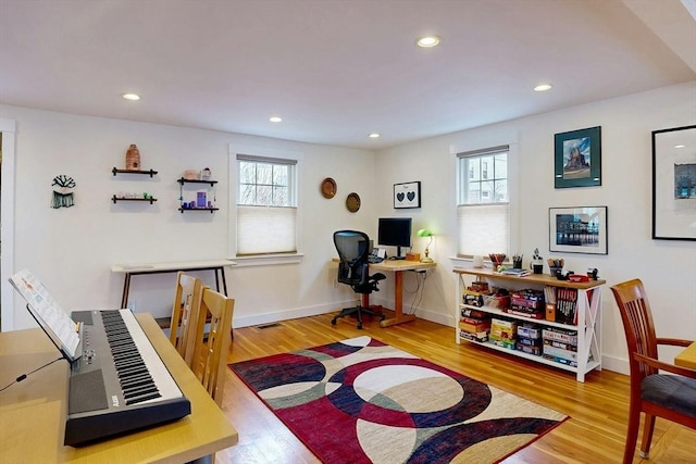 home office featuring recessed lighting, wood finished floors, and a wealth of natural light