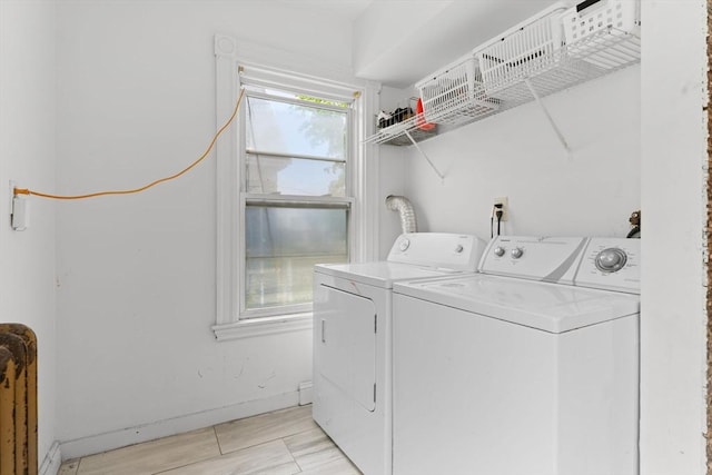 washroom featuring washing machine and clothes dryer and baseboards