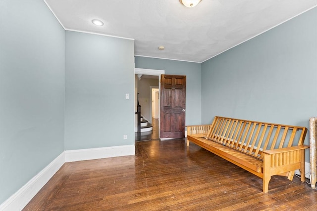 bedroom with baseboards, wood finished floors, and crown molding