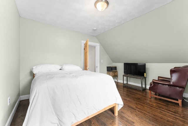 bedroom with wood finished floors, baseboards, and vaulted ceiling