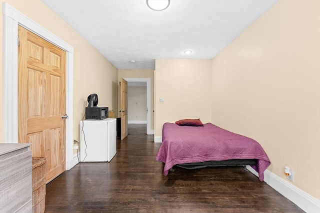 bedroom with wood finished floors, baseboards, and recessed lighting