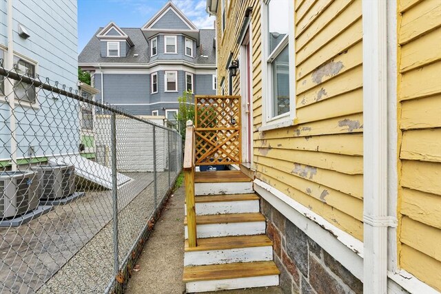 view of yard featuring fence and central air condition unit