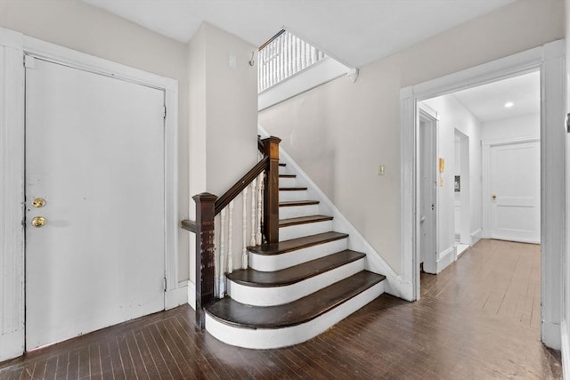 staircase featuring wood-type flooring