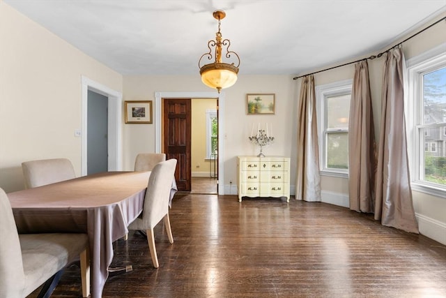 dining space featuring hardwood / wood-style floors, plenty of natural light, and baseboards
