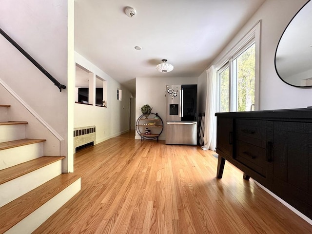 84 Walden Ter, Concord, MA 01742 - interior space featuring radiator, stairway, light wood finished floors, and baseboards