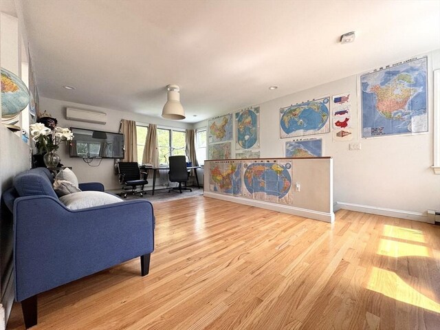 84 Walden Ter, Concord, MA 01742 - living area with a wall mounted AC, light wood-style floors, and baseboards