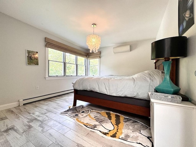 84 Walden Ter, Concord, MA 01742 - bedroom featuring a baseboard heating unit, an AC wall unit, wood finished floors, and baseboards