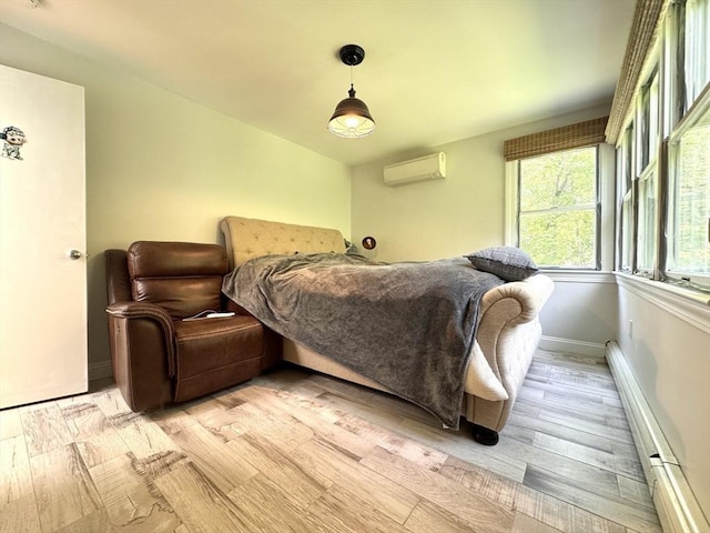 84 Walden Ter, Concord, MA 01742 - bedroom with a wall unit AC, light wood finished floors, baseboards, and a baseboard heating unit
