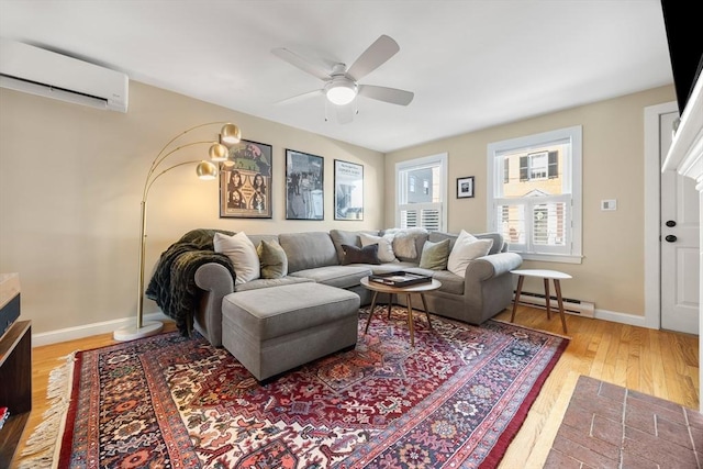 living room with a wall unit AC, a ceiling fan, baseboards, light wood finished floors, and a baseboard radiator