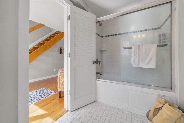 full bathroom with shower / washtub combination, baseboards, and wood finished floors