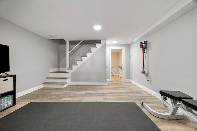 workout room featuring baseboards and wood finished floors