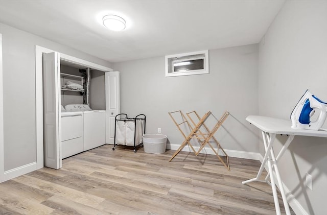 clothes washing area with laundry area, light wood-style flooring, baseboards, and independent washer and dryer