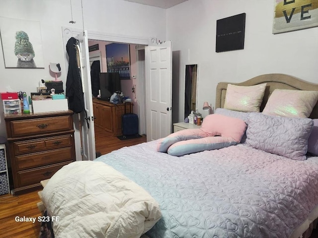 bedroom featuring a closet and wood finished floors