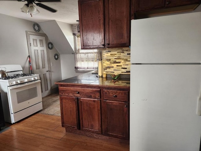 kitchen with white appliances, wood finished floors, tasteful backsplash, and ceiling fan