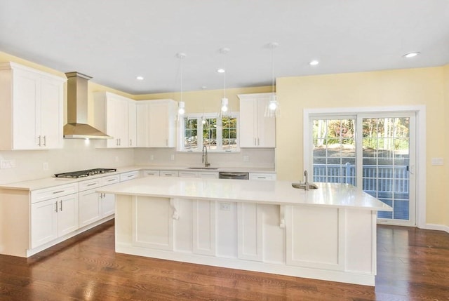 390 Marshall St, Leicester, MA 01524 - kitchen with appliances with stainless steel finishes, a kitchen island, sink, wall chimney range hood, and white cabinetry
