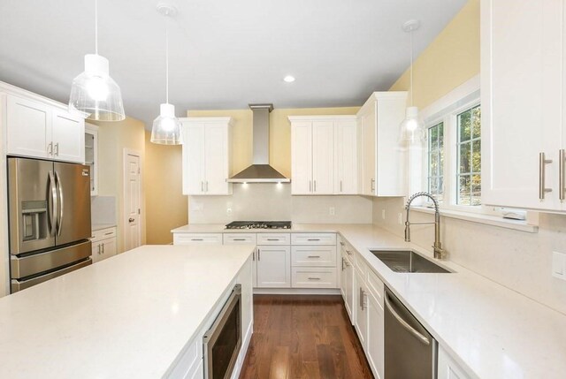 390 Marshall St, Leicester, MA 01524 - kitchen with white cabinetry, sink, wall chimney exhaust hood, stainless steel appliances, and decorative light fixtures