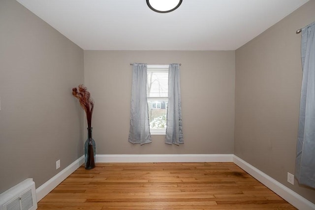 empty room with light hardwood / wood-style flooring