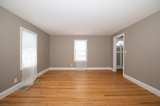 spare room featuring light hardwood / wood-style flooring