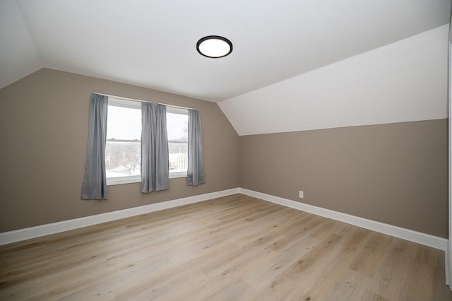 bonus room featuring vaulted ceiling and light hardwood / wood-style flooring